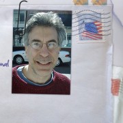 Envelope with canceled stamp and a photo paperclipped to it